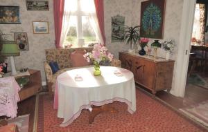 a living room with a table with a vase of flowers on it at Stunning Home In Blidsberg With 2 Bedrooms in Älmestad