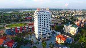 an overhead view of a city with a tall white building at Kim Bao Hotel in Hải Dương