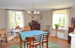a dining room with a blue table and chairs at Amazing Home In Lammhult With Kitchen in Lammhult