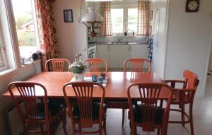 een eetkamer met een houten tafel en stoelen bij Beautiful Home In Grsns With Kitchen in Gärsnäs