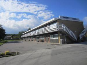 a building with a parking lot in front of it at Hotel Lisboa in Frederikshavn