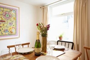 a dining room table with a bottle of wine and glasses at Host & Stay - Dane Hill in Margate