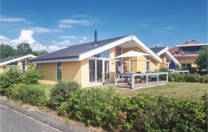 a yellow house with a picnic table in the yard at Amazing Home In Rechlin With Wifi in Rechlin
