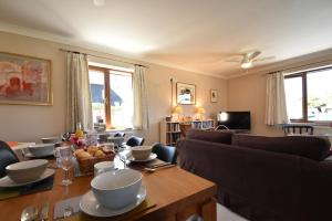 a living room with a table and a couch at Stoats Old River Way in Winchelsea