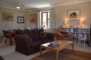 a living room with a couch and a table at Stoats Old River Way in Winchelsea