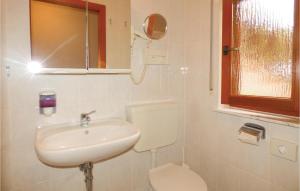 a white bathroom with a sink and a toilet at Ferienhaus 22 In Thalfang in Thalfang