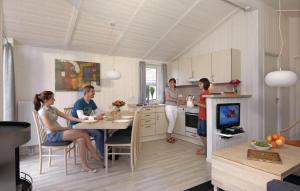 a group of people sitting at a table in a kitchen at Schatzkiste 16 - Dorf 4 in Travemünde