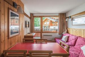 a living room with a couch and a table at Residence Plagne Lauze - maeva Home in Plagne 1800