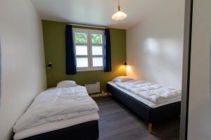 Säng eller sängar i ett rum på Østersø kystlejligheder