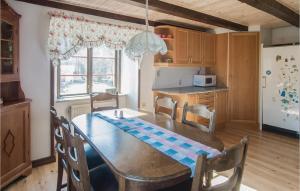 a dining room with a table and a kitchen at Lovely Apartment In Havdhem With Wifi in Havdhem