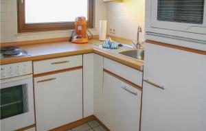 a kitchen with a sink and a white refrigerator at Ferienhaus 15 In Kirchheim in Kirchheim