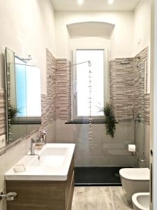 a bathroom with a sink and a toilet and a shower at Mare&Sentieri Apartment in La Spezia