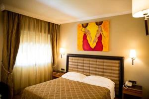 Postel nebo postele na pokoji v ubytování Hotel Ares
