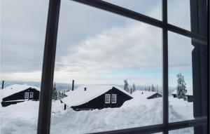 a view from a window of snow covered houses at Cozy Home In Lillehammer With Wifi in Lillehammer