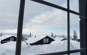 a view from a window of snow covered houses at Stunning Home In Lillehammer With 4 Bedrooms And Wifi in Lillehammer