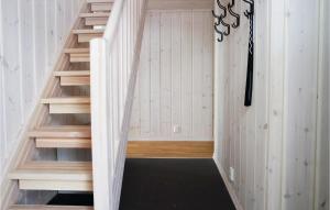 a staircase in a room with white walls and wood at Cozy Home In Lillehammer With Wifi in Lillehammer