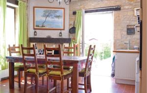 una sala da pranzo con tavolo e alcune sedie di Awesome Home In Puy Levque With Private Swimming Pool, Can Be Inside Or Outside a Puy-lʼÉvêque