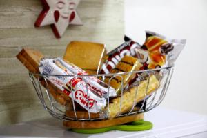 a basket filled with sandwiches and snacks on a shelf at Sweet Home in Francavilla di Sicilia