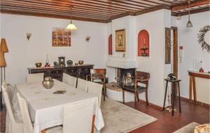 a dining room with a table and a fireplace at Stunning Home In Portaria With Kitchen in Portaria