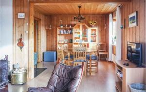 a living room with a table and a dining room at Three-Bedroom Holiday Home In Sjusjoen in Sjusjøen