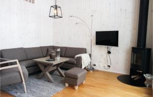 a living room with a couch and a table and a tv at Cozy Home In Lillehammer With Wifi in Lillehammer