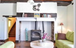 a living room with a fireplace and a couch at Cozy Home In Puy Levêque in Puy-lʼÉvêque