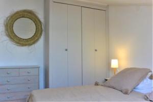 a bedroom with a bed and a mirror and a dresser at CANELLA 2 in Favone