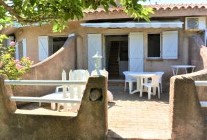 a house with a patio with chairs and tables at CANELLA 2 in Favone +2 photos