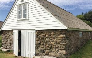 an old stone building with a window and a door at Holiday Home Vanse Østhasselstrand Ii in Vanse
