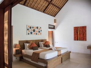 a bedroom with a bed in a room at Villa Sepoi Sepoi by Elite Havens in Tanjung +44 photos