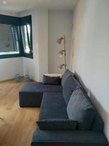 sala de estar con 2 camas y sofá en Apartamento Camiño dos Faros en Ponteceso