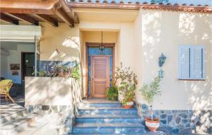 a home with stairs leading to a wooden door at Nice Home In Arcos De La Frontera With Swimming Pool in Arcos de la Frontera