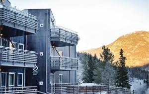 a building with balconies and a mountain in the background at Nice Apartment In Hemsedal With Sauna in Hemsedal
