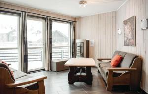 a living room with a couch and a table at 3 Bedroom Nice Apartment In Hemsedal in Hemsedal