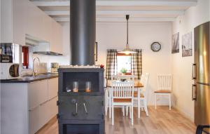 a kitchen and dining room with an old stove at Klitterbyn 16 in Ängelholm