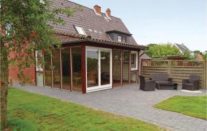 an orangery with glass doors and a patio at Stunning Home In Gelting With Kitchen in Gelting