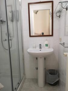 a bathroom with a sink and a mirror and a shower at B&B Palazzo Antonelli in Monopoli +33 photos