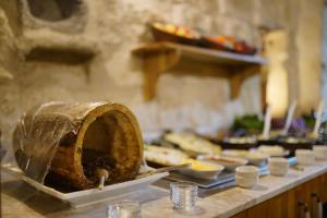 a table with a loaf of bread and other food on it at Taru Cave Suites in Urgup