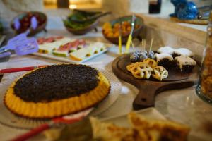 a table topped with different types of cakes and desserts at Taru Cave Suites in Urgup