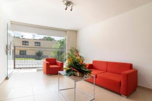 uma sala de estar com dois sofás vermelhos e uma mesa em Ayenda 1240 Megua em Medellín