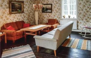 a living room with a table and chairs and a couch at One-Bedroom Holiday Home In Vislanda in Vislanda