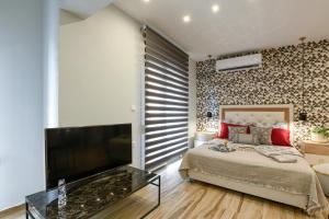 A bed or beds in a room at Adell Luxury Apartments