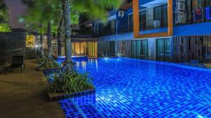 a large blue swimming pool in front of a building at Naiharn Relife by Nataly in Nai Harn Beach