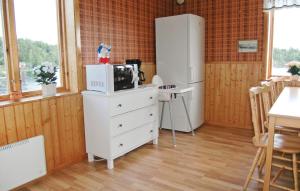 a kitchen with a white refrigerator and a white dresser at Holiday Home Spångens Motorbåtsklubb Åsensbruk in Åsensbruk +17 photos