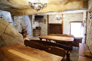 a living room with a table and chairs and a chandelier at Galabova Guesthouse in Delchevo +12 photos