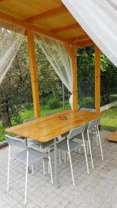 a wooden table and chairs under a gazebo at Cracow Family House in Kraków