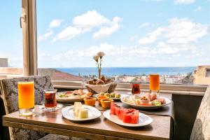 a table with plates of food and a view of the ocean at AHC Grand Bazaar Hotel in Istanbul