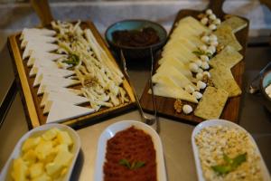 a table with different types of cheese and other foods at Taru Cave Suites in Urgup