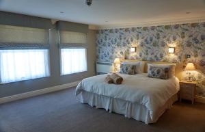a bedroom with a large bed and a large window at Franklins Apartments in York