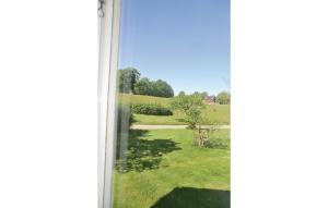 a window with a view of a field at Holiday Home Holmsjövägen Holmsjö Ii in Holmsjö